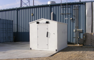 Safe Shed storm shelter installed outside man door of manufacturing facility.